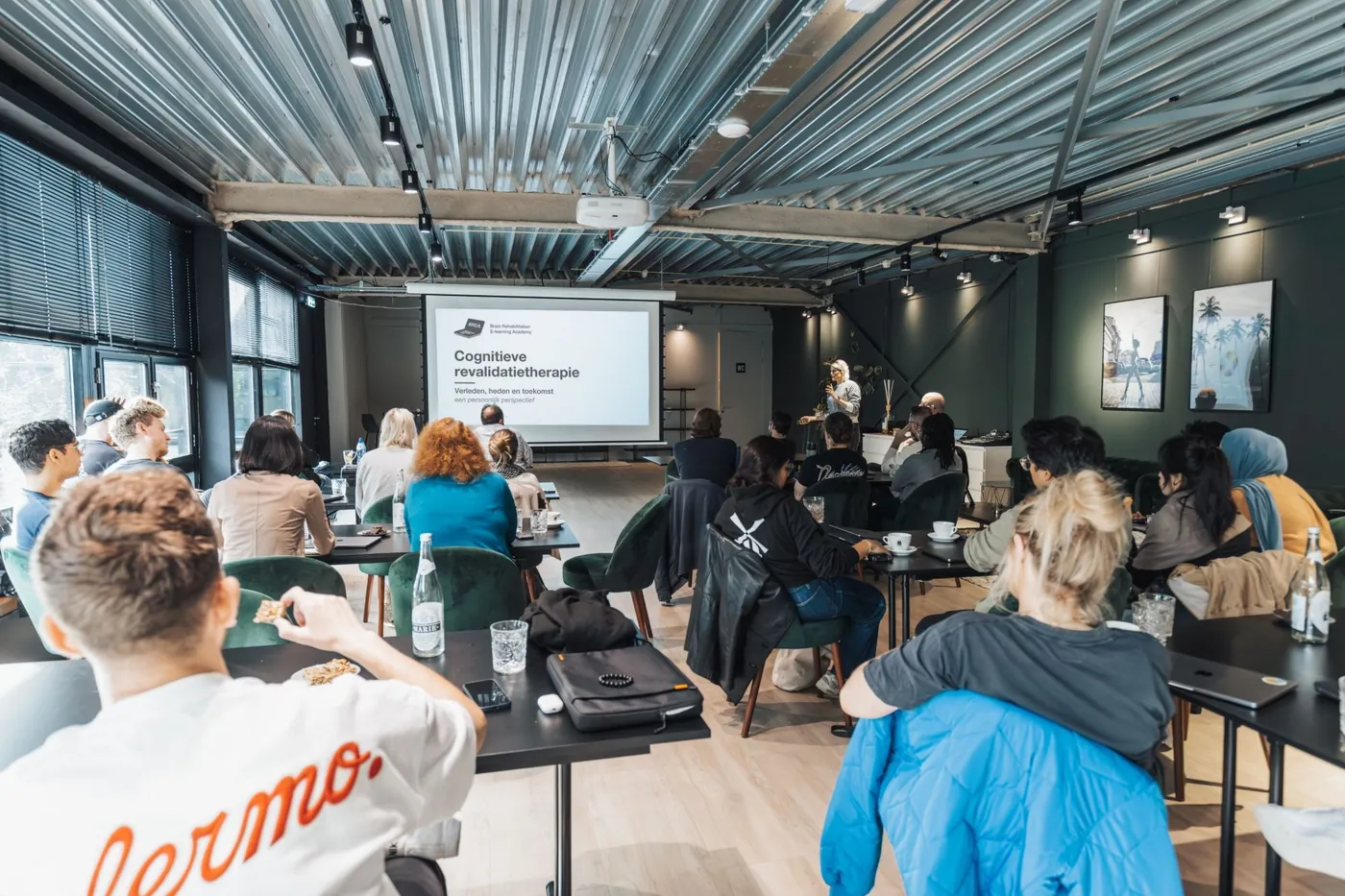 A BREA in-company training: a group at tables listening to a talk on cognitive rehabilitation therapy.